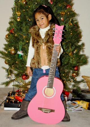 Santa granted Sophie's Christmas wish for a pink "gitara." Is she getting influenced by her big brothers to be a future Rock Star too?