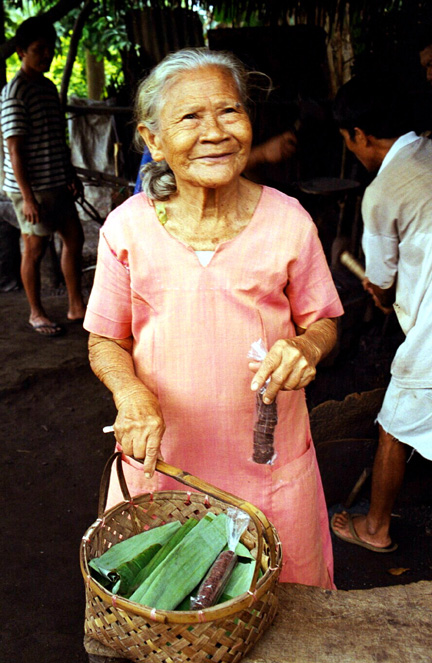 Woman selling cacao boullions - unrefined chocolate. Cacao is the origin of chocolate. We bought some to take home to try out as instructed.