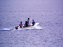 a couple of guest being taken to a scuba diving spot.