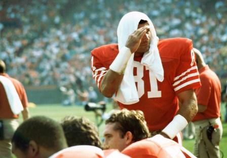 Russ Francis salutes a fans at the stands 